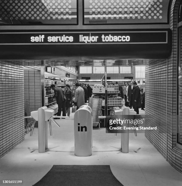 New duty free shop at Heathrow Airport in London, advertising 'Self Service Liquor Tobacco', UK, 7th March 1972.