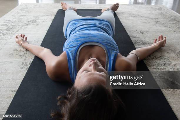 woman shavasana hatha yoga pose - yoga pose photos et images de collection