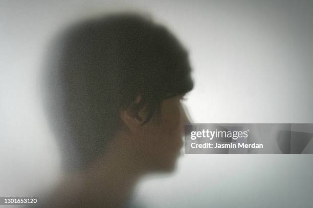 person behind shadow glass - grumpy man stock pictures, royalty-free photos & images