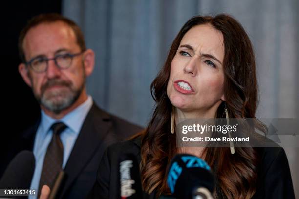 Minister of Health Andrew Little listens to New Zealand Prime Minister Jacinda Ardern speaking at the announcement about the arrival of the...