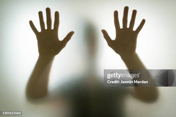 hands on glass shadow - frosted glass stockfoto's en -beelden