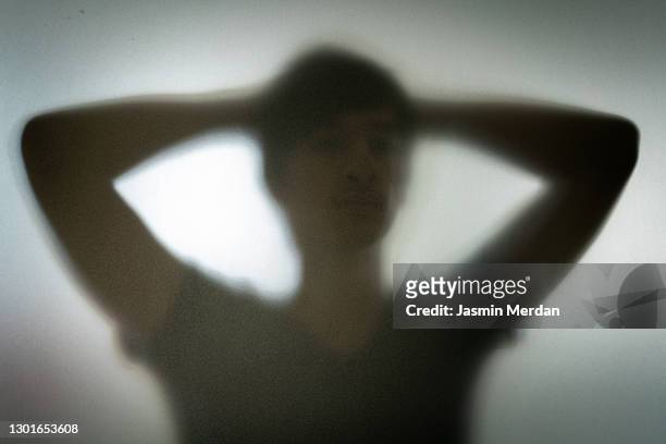 person behind shadow glass - victim silhouette stock pictures, royalty-free photos & images