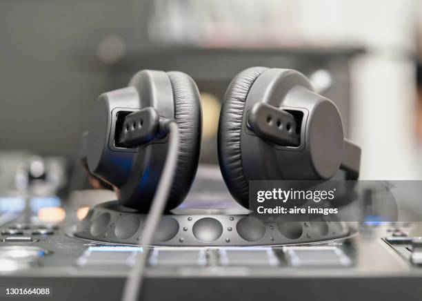 headphones on professional sound mixer console. - dj table stock pictures, royalty-free photos & images