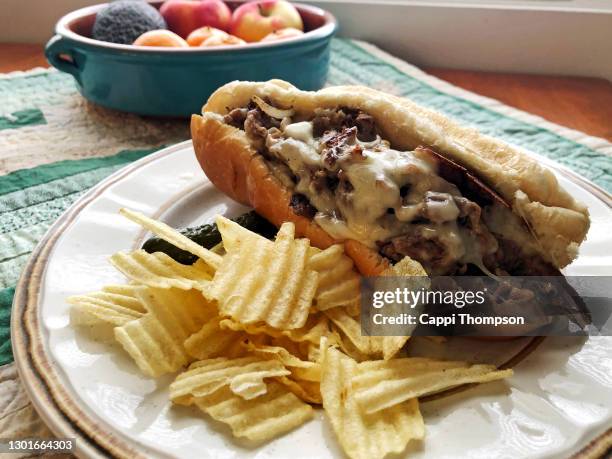 steak and cheese sub sandwich ready to eat with chips - roast beef sandwich stock pictures, royalty-free photos & images