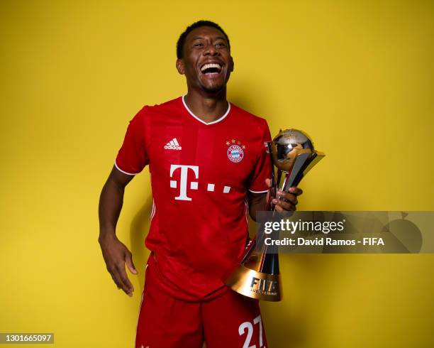 David Alaba of FC Bayern Muenchen poses with the trophy after winning the FIFA Club World Cup Qatar 2020 Final between FC Bayern Muenchen and Tigres...