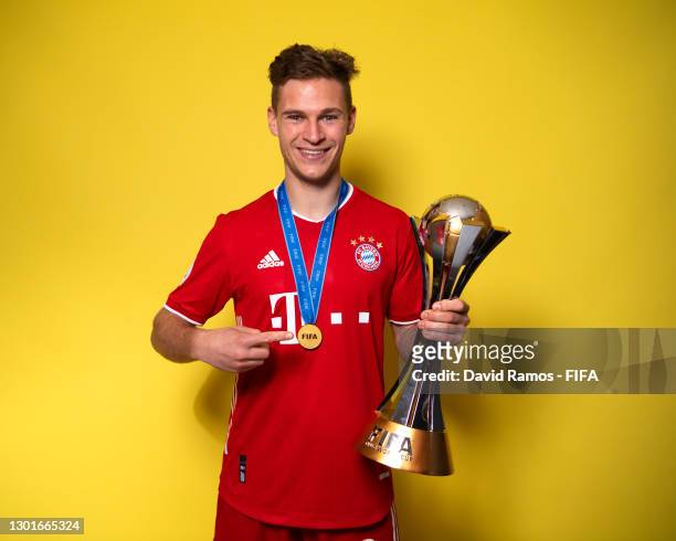 Joshua Kimmich of FC Bayern Muenchen poses with the trophy after winning the FIFA Club World Cup Qatar 2020 Final between FC Bayern Muenchen and...