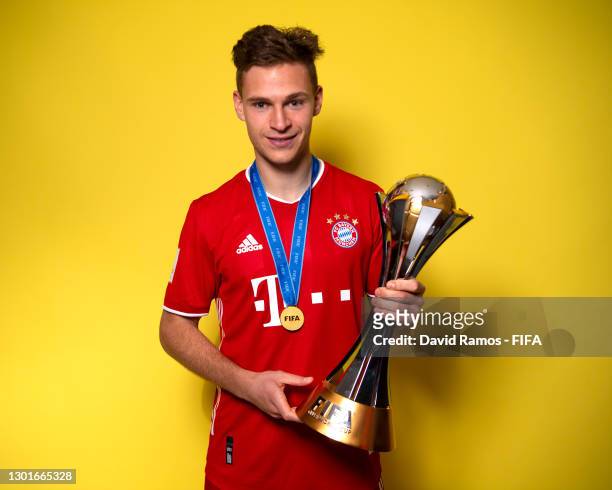 Joshua Kimmich of FC Bayern Muenchen poses with the trophy after winning the FIFA Club World Cup Qatar 2020 Final between FC Bayern Muenchen and...