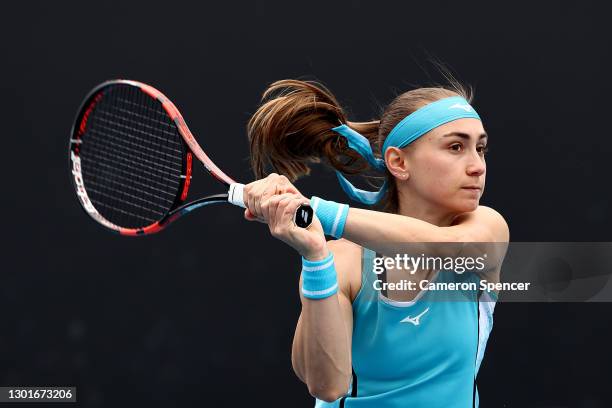 Aleksandra Krunic of Serbia plays a backhand in her Women's Doubles second round match with partner Martina Trevisan of Italy against Mona Barthel of...