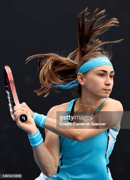 Aleksandra Krunic of Serbia plays a backhand in her Women's Doubles second round match with partner Martina Trevisan of Italy against Mona Barthel of...
