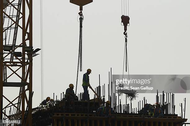 Workers stand on the construction site of a new office building in the budding new financial district on October 23, 2011 in Doha, Qatar. Qatar will...