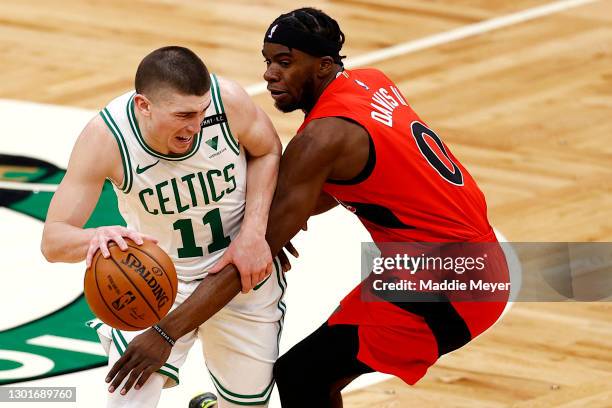 Terence Davis of the Toronto Raptors defends Payton Pritchard of the Boston Celtics during the third quarter at TD Garden on February 11, 2021 in...