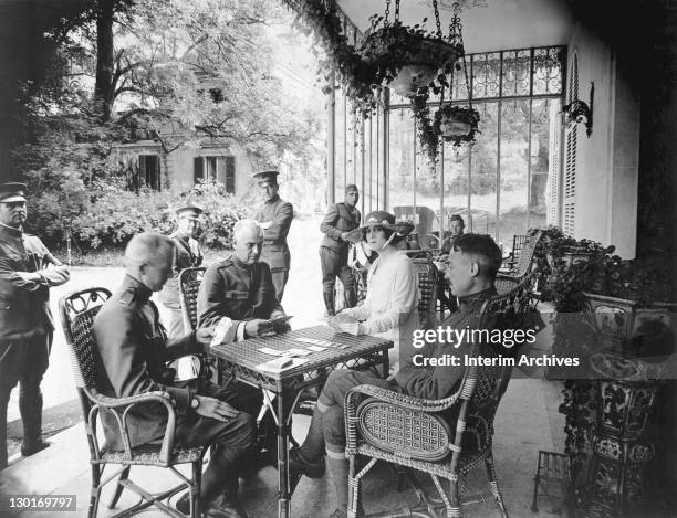 At Chateau de Villegenis, her home in Palaiseau, France, Mrs. Mabel Gilman Corey, wife of US Steel president William E. Corey, plays a game of bridge...