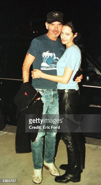 Newly married Billy Bob Thornton and Angelina Jolie pose for a photographer outside Jerry''s Famous Deli June 3, 2000 in Studio City, CA.