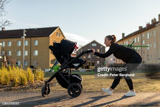 mother exercising with her baby - baby pram in the park stock pictures, royalty-free photos & images