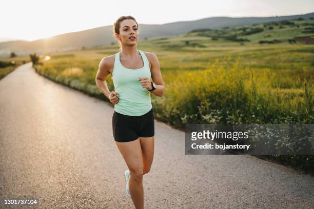 jogging is her favorite exercise - jogging stock pictures, royalty-free photos & images