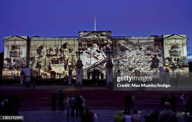 Photograph showing the then Princess Elizabeth and Princess Margaret is projected, alongside photographs of bomb damage and other war-time scenes,...