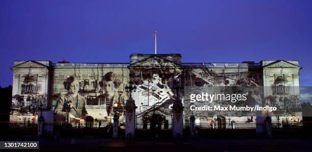 Photograph showing the then Princess Elizabeth and Princess Margaret is projected, alongside photographs of bomb damage and other war-time scenes,...