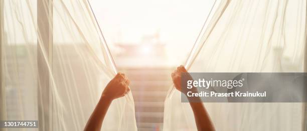 man and hope concept . man opening window curtains - curtains blowing stock pictures, royalty-free photos & images