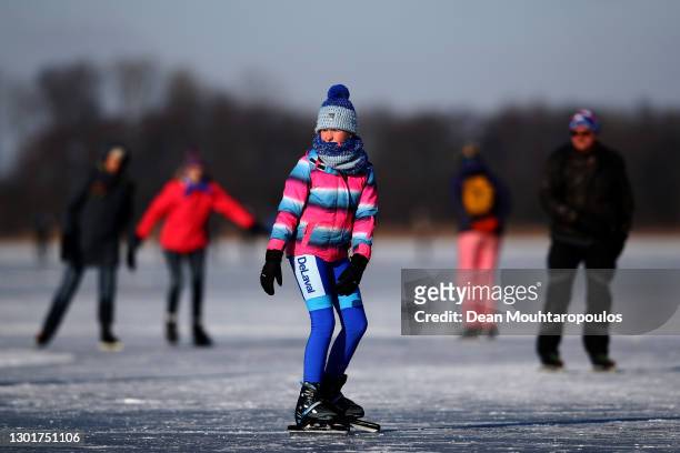 Oudehaske, NETHERLANDS People skate on the Nannewiid, a lake frozen over as temperatures stay below zero and locals enjoy activities like speed...