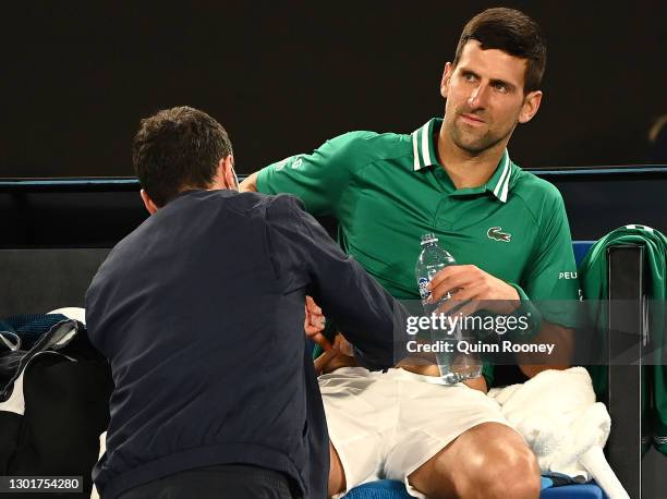 Novak Djokovic of Serbia received medical treatment in his Men's Singles third round match against Taylor Fritz of the United Statesduring day five...