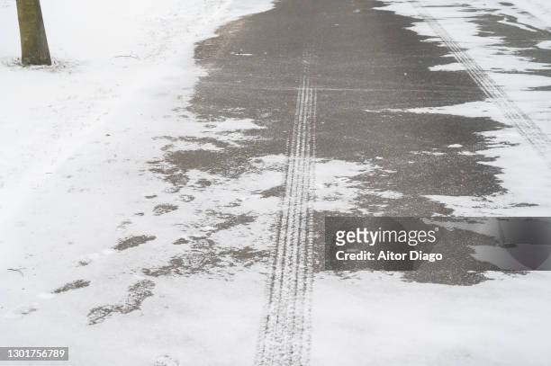 iced asphalt of a road. germany - snow squall fotografías e imágenes de stock