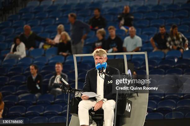 The chair umpire reads a note saying patrons must leave at 11.30 PM due to Victorian Covid restriction during the Novak Djokovic of Serbia Men's...