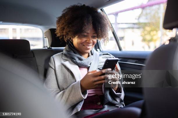 african woman traveling in a taxi - crowdsourced taxi stock pictures, royalty-free photos & images