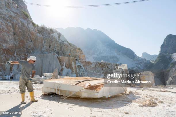 worker cutting block of marble in quarry with wire saw - marble quarry ストックフォトと画像