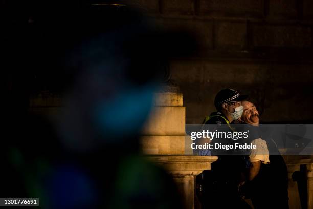Protester is detained by Police at an anti lockdown protest in front of Parliament House, following the announcement of the lockdown on February 12,...