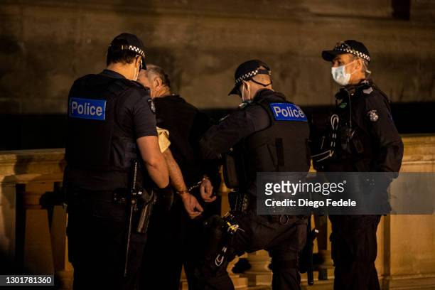 Protester is being detained by the Police at an anti lockdown protest in front of Parliament House, following the announcement of the lockdown on...