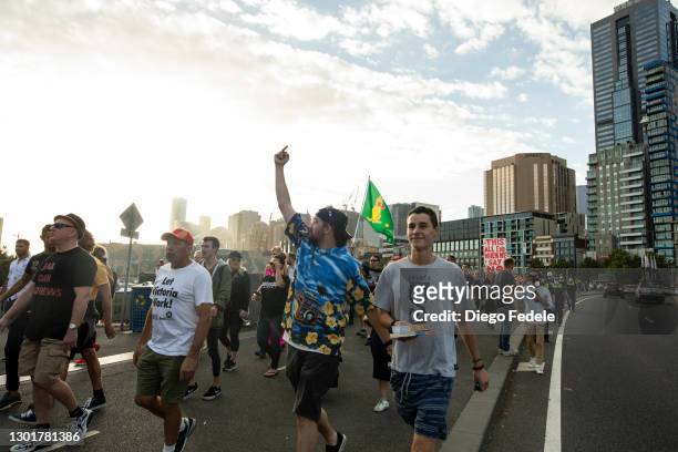 Anti lockdown protesters are seen marching towards the Rod Lavern Arena, following the announcement of the lockdown on February 12, 2021 in...