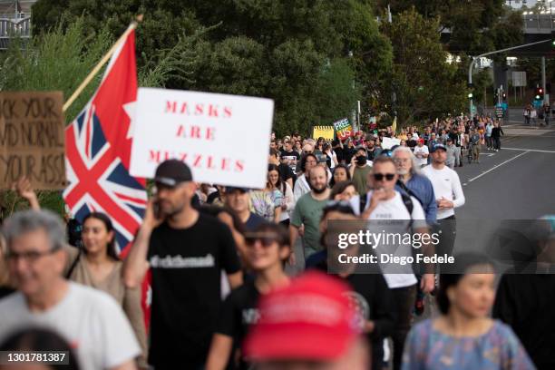Anti lockdown protesters are seen marching towards Parliament House, following the announcement of the lockdown on February 12, 2021 in Melbourne,...