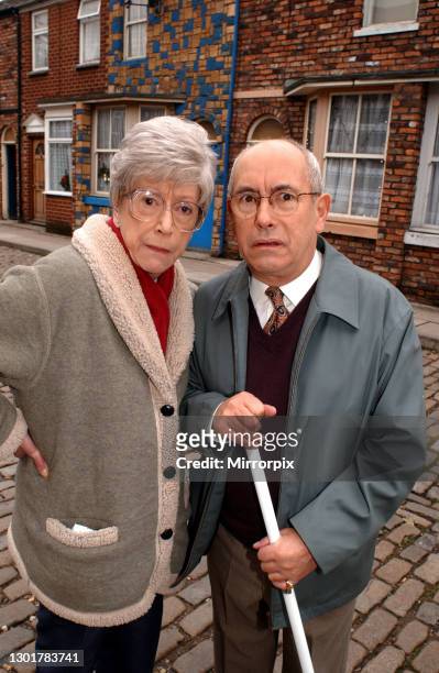 Actors Malcolm Hebden and Maggie Jones on the set of the British soap opera 'Coronation Street', Manchester, November 2002. They play the roles of...