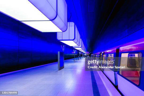 illuminated subway station in hamburg, germany - train vehicle stock pictures, royalty-free photos & images