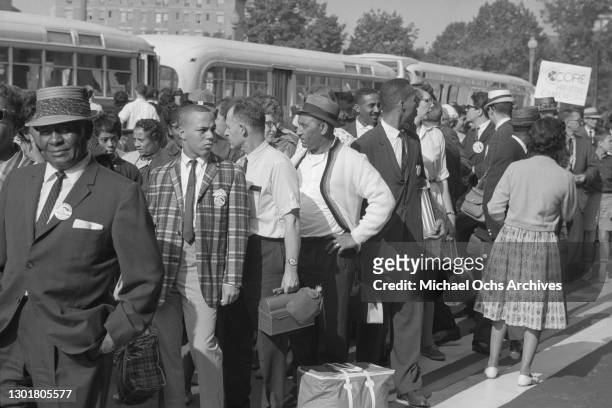 Marchers arrive by bus holding a "CORE Downtown" sign before the March on Washington on August 28, 1963 in Washington DC.
