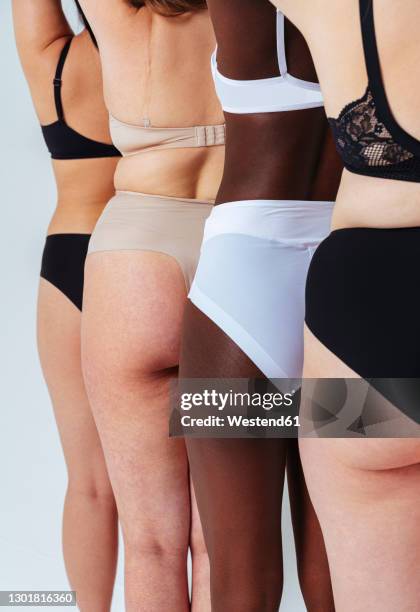 friends wearing lingerie standing in a line at studio - gluteos fotografías e imágenes de stock