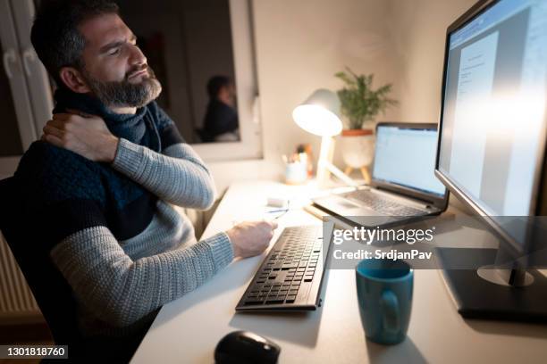 tired businessman working late in his home office - posture stock pictures, royalty-free photos & images