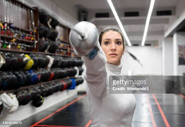 womanin fencing outfit practicing at gym - tin foil hat stock-fotos und bilder