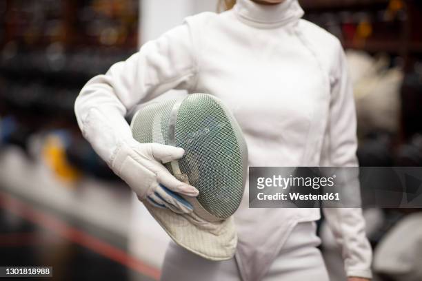 womanin fencing outfit standing at gym - fäktningsmask bildbanksfoton och bilder