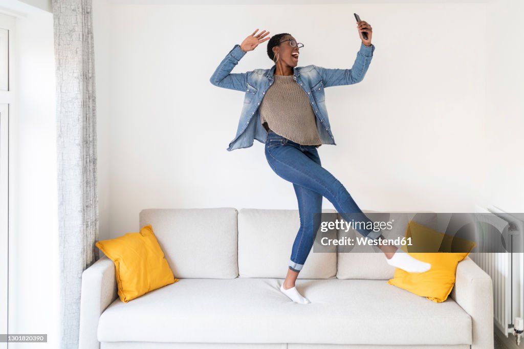 Woman dancing on sofa