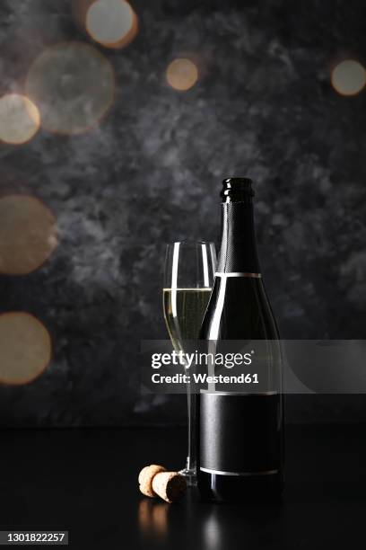 studio shot of glass and bottle of champagne - champagne cork ストックフォトと画像