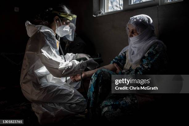 Nurse, Bilge Koc from the Gevas Public Health Center vaccination team takes the blood pressure of 74 year-old Basra Payza after she was administered...