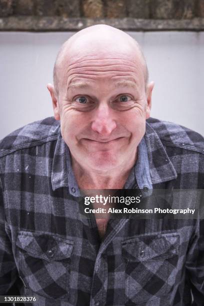 head shot of a bald man in his fifties pulling an ugly face - ugly bald man stock pictures, royalty-free photos & images