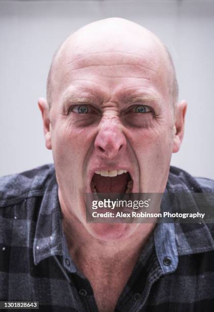 head shot of a bald man in his fifties shouting - ugly bald man stock pictures, royalty-free photos & images