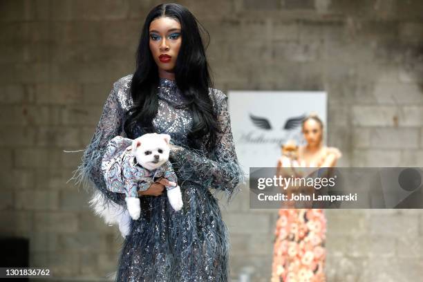 Models walk the runway with a dog during Anthony Rubio's Women's Wear Canine Couture show during New York Fashion Week at Ideal Glass Studios on...