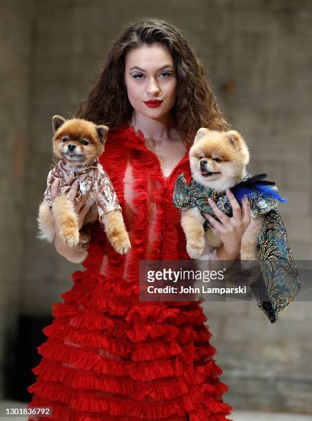 Model poses with dogs during Anthony Rubio's Women's Wear Canine Couture show during New York Fashion Week at Ideal Glass Studios on February 12,...