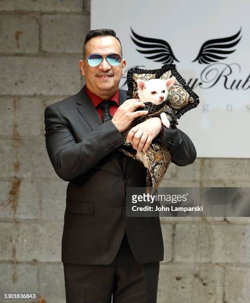 Designer Anthony Rubio poses with a dog during Anthony Rubio's Women's Wear Canine Couture show during New York Fashion Week at Ideal Glass Studios...