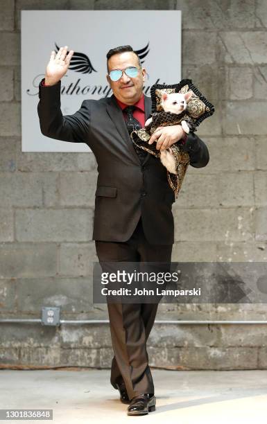 Designer Anthony Rubio poses with a dog during Anthony Rubio's Women's Wear Canine Couture show during New York Fashion Week at Ideal Glass Studios...