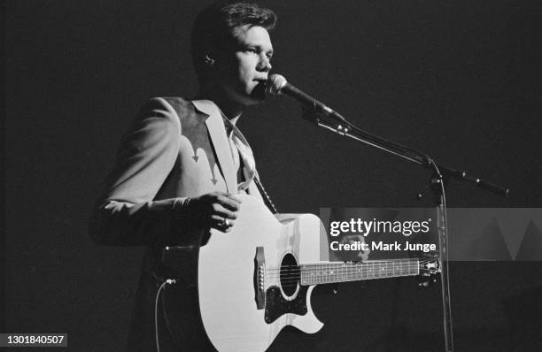 Randy Bruce Traywick, better known as Randy Travis, performs at the Cheyenne Frontier Days rodeo grounds on July, 1987 in Cheyenne, Wyoming. A...