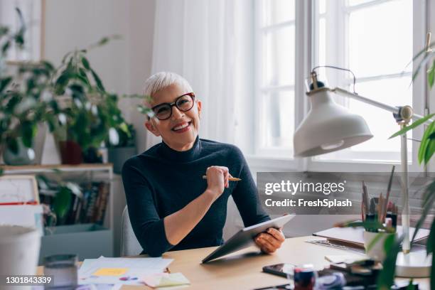 portrait of a smiling senior civil engineer working on a project in her office - civilperson stock pictures, royalty-free photos & images